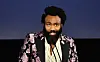 Donald Glover, wearing Gucci, speaks onstage during the 2019 LACMA Art + Film Gala .