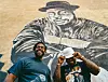 Jam Master Jays owners in front of jam master jay mural