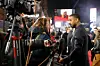 Michael B. Jordan at the premiere of Creed III dressed in a suit and speaking to reporters.