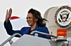 US Vice President and Democratic presidential candidate Kamala Harris waves as she steps off Air Force Two upon arrival at Chicago O'Hare International Airport in Chicago, Illinois, after a day of campaigning by bus in Pennsylvania, on August 18, 2024.