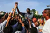 Former NBA basketball player Dikembe Mutombo and Cuban children cheer during a clinical organized by the NBA, FIBA Americas and Cuban Basketball Federation on April 24, 2015, in Havana.